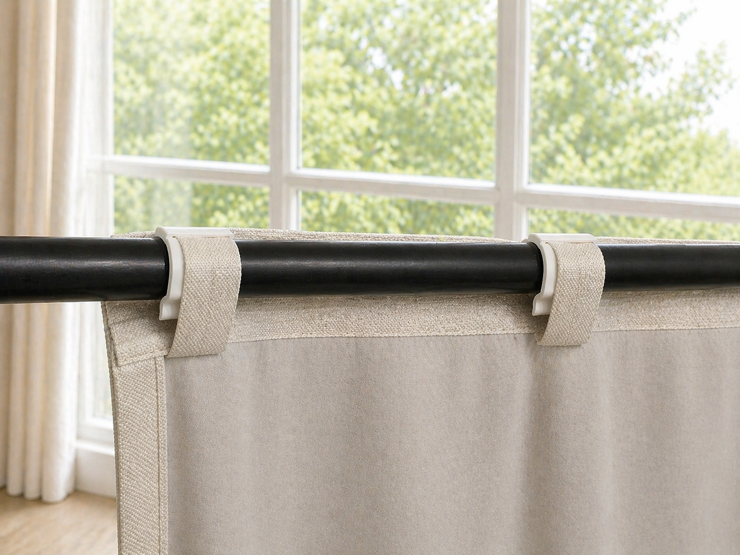 SilkSlide clips gripping curtain back tabs on a rod, smooth glide guaranteed